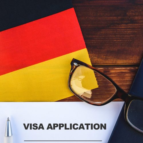 Flag of Germany , visa application form and passport on table